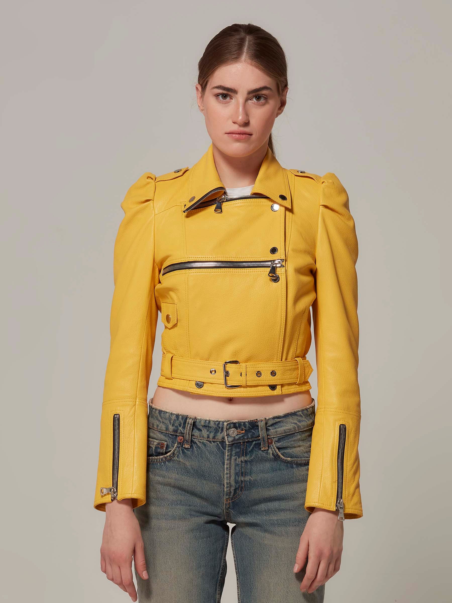 woman in cropped yellow biker jacket puffy shoulder genuine leather standing front view