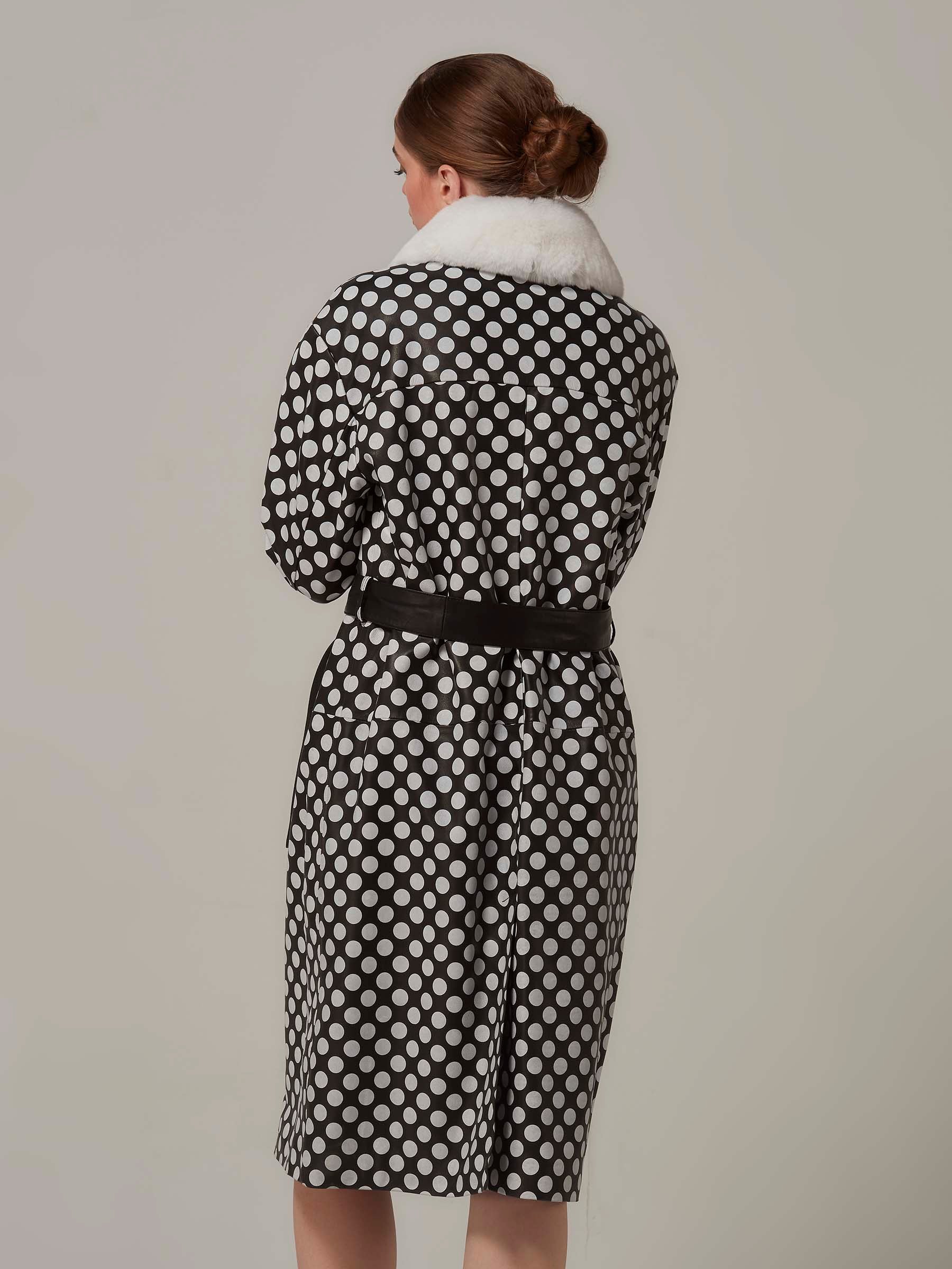  Back view of a stylish woman in a Black and White Leather Coat with Polka Dot and Rex Fur Collar. Full length.