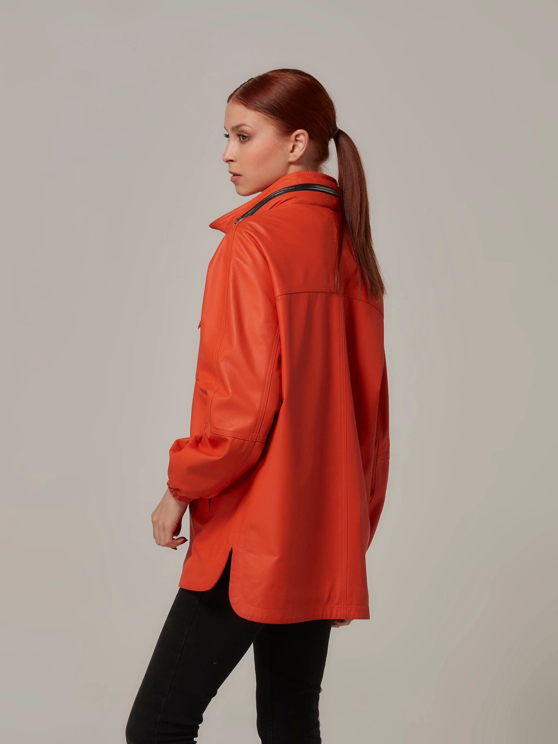 Matte Orange Leather Jacket with Hood Minimalist Design side pose close up